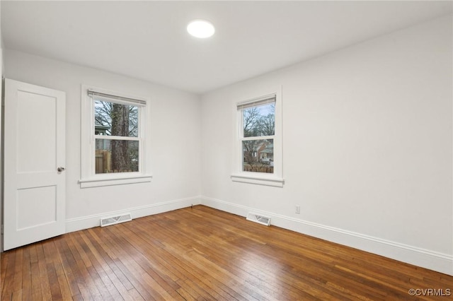 spare room featuring hardwood / wood-style floors and a wealth of natural light