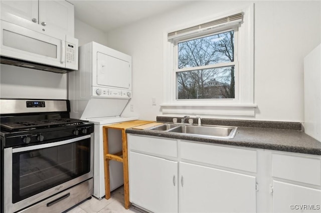 kitchen with white cabinetry, sink, and stainless steel gas range