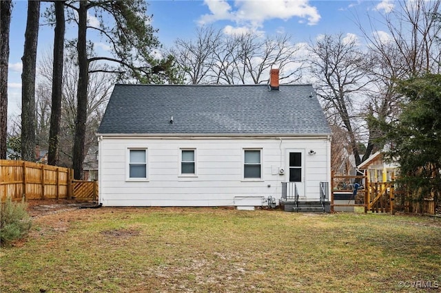 rear view of house with a yard