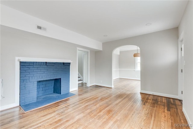 unfurnished living room featuring hardwood / wood-style flooring and a fireplace