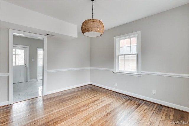 spare room featuring light wood-type flooring