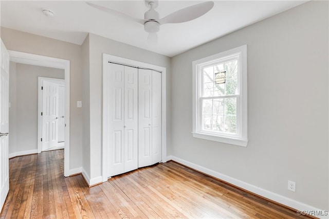 unfurnished bedroom featuring a closet, ceiling fan, and light hardwood / wood-style flooring