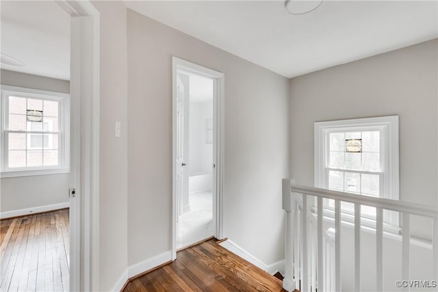 hallway with dark hardwood / wood-style flooring