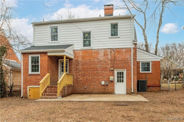 rear view of house featuring central AC unit and a patio