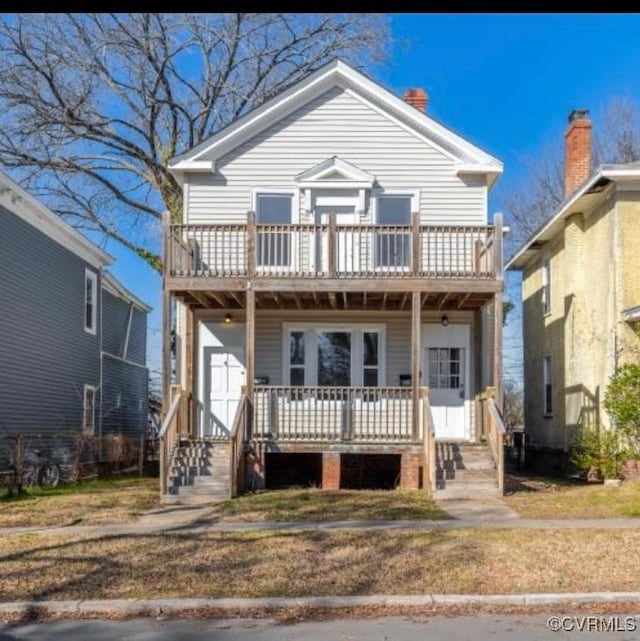 view of front property with a porch and a balcony