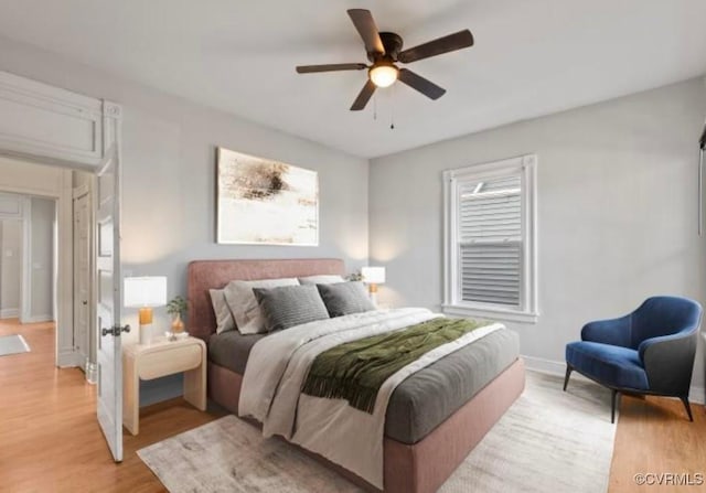 bedroom with ceiling fan and light wood-type flooring