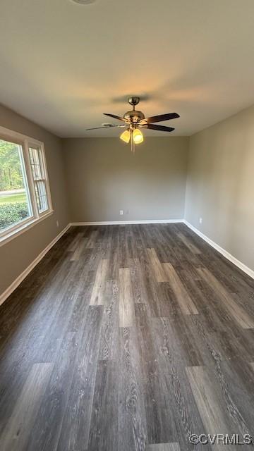 unfurnished room featuring dark wood-type flooring and ceiling fan