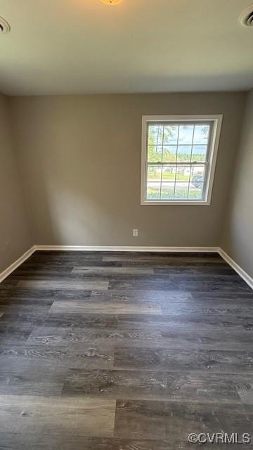 unfurnished room with dark hardwood / wood-style flooring