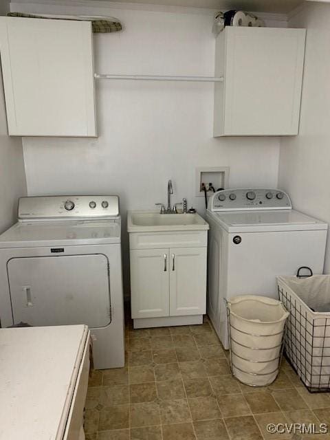 laundry area with washer and dryer, sink, and cabinets