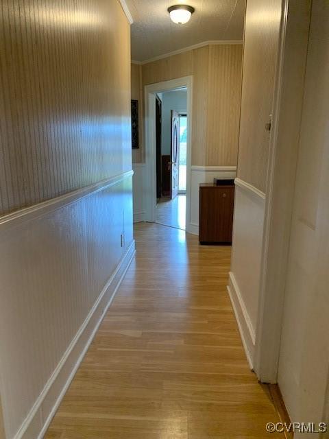 hall featuring ornamental molding and light wood-type flooring