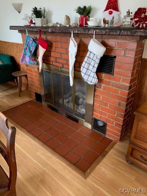 interior details featuring wood-type flooring and a fireplace