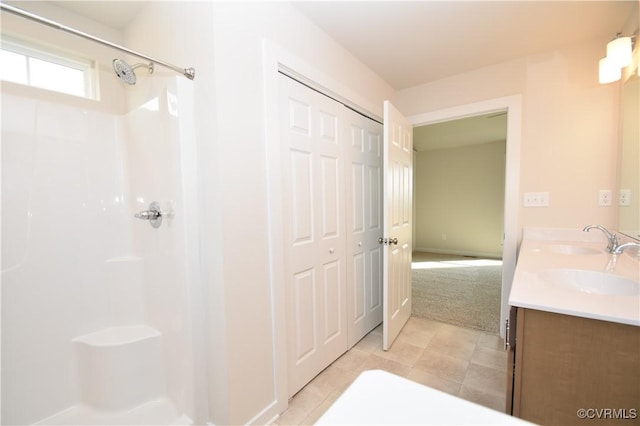 bathroom with vanity and a shower