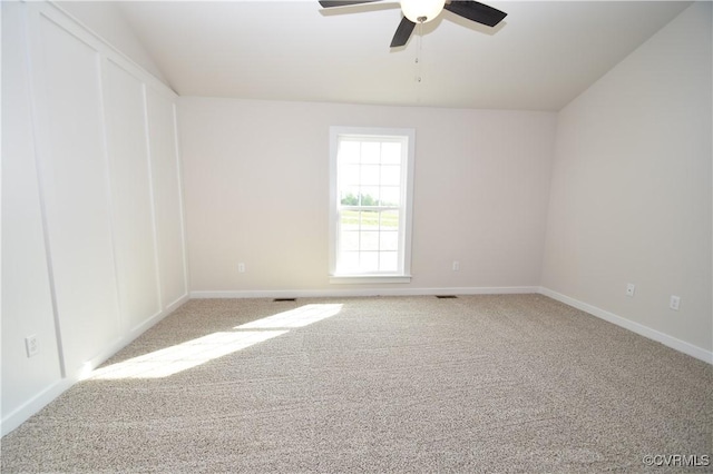 carpeted spare room featuring ceiling fan