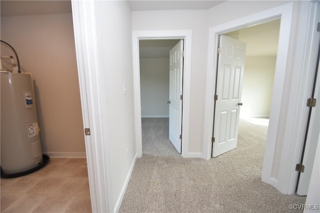 corridor with water heater and light colored carpet