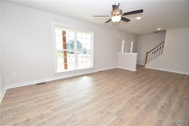 unfurnished living room with wood-type flooring and ceiling fan