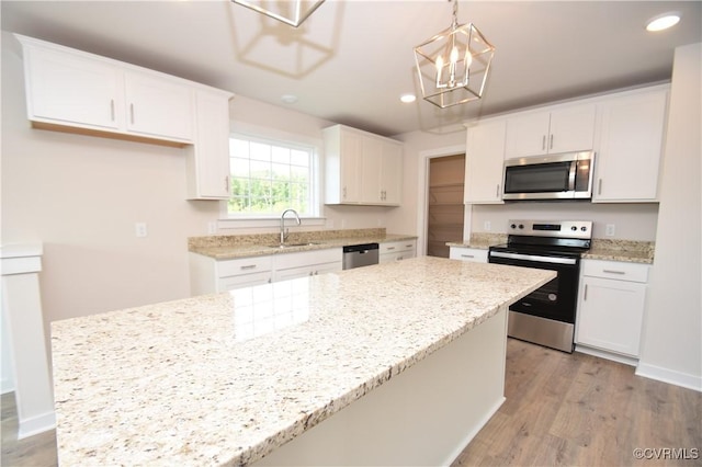 kitchen with white cabinetry, appliances with stainless steel finishes, and a kitchen island