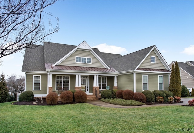 craftsman-style house with a front lawn and covered porch