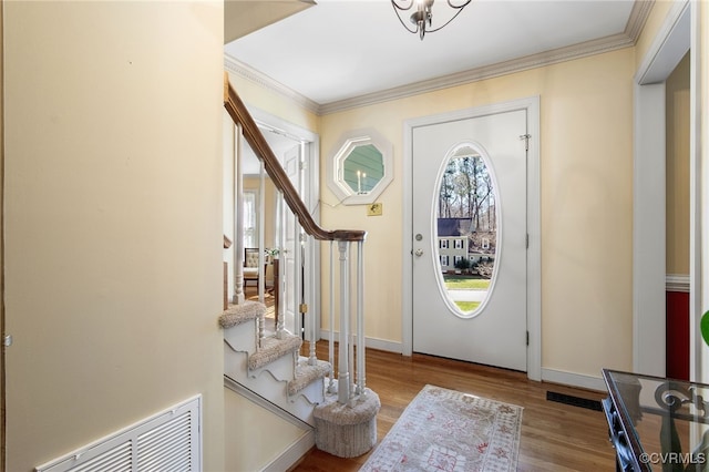 foyer entrance featuring light hardwood / wood-style flooring and ornamental molding