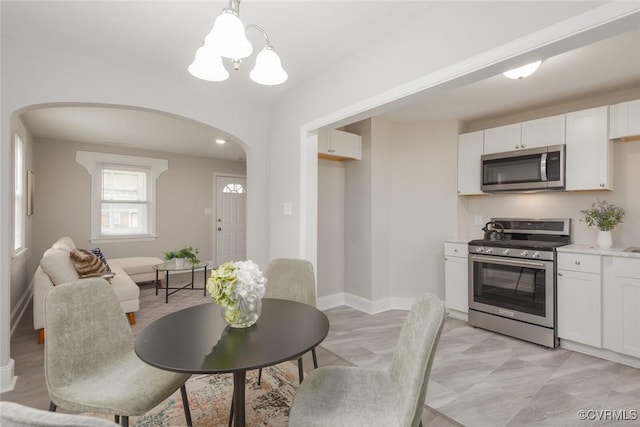 dining space with an inviting chandelier