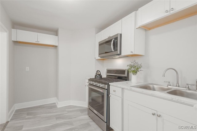 kitchen featuring white cabinetry, appliances with stainless steel finishes, and sink