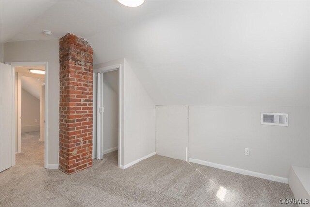 bonus room featuring light colored carpet and lofted ceiling