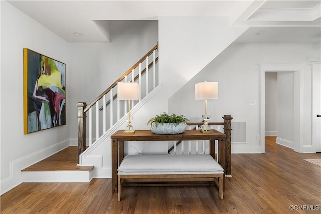 staircase with hardwood / wood-style floors