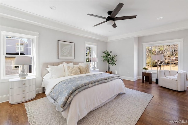 bedroom with ornamental molding, dark wood-type flooring, and ceiling fan