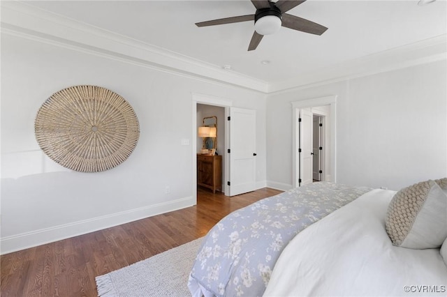 bedroom with crown molding, hardwood / wood-style flooring, and ceiling fan