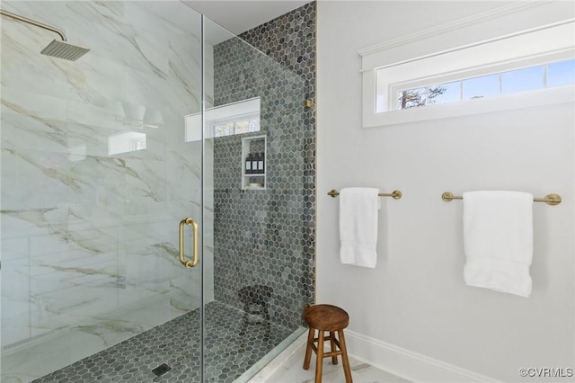 bathroom featuring a shower with door