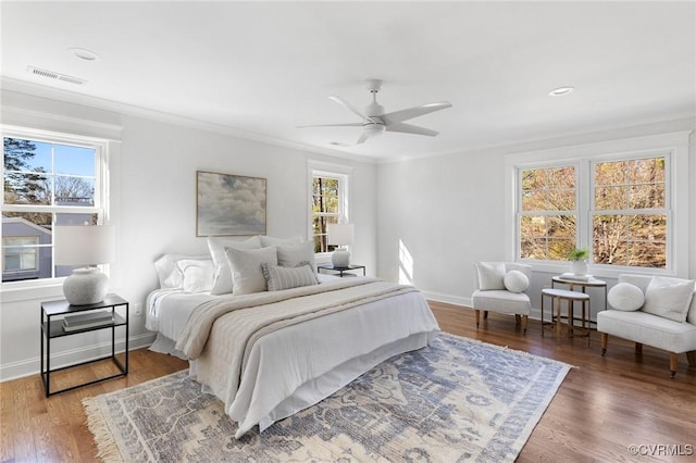 bedroom featuring crown molding, ceiling fan, and dark hardwood / wood-style floors