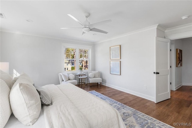 bedroom with crown molding, dark wood-type flooring, and ceiling fan