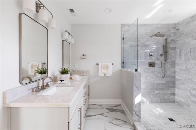 bathroom with vanity and a tile shower