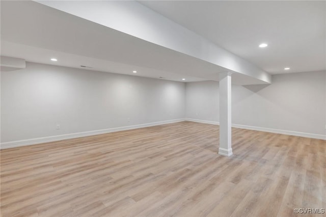 basement with light hardwood / wood-style flooring