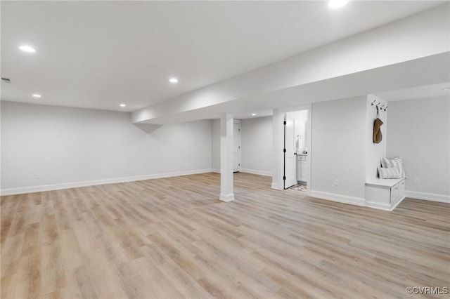 basement with light hardwood / wood-style flooring