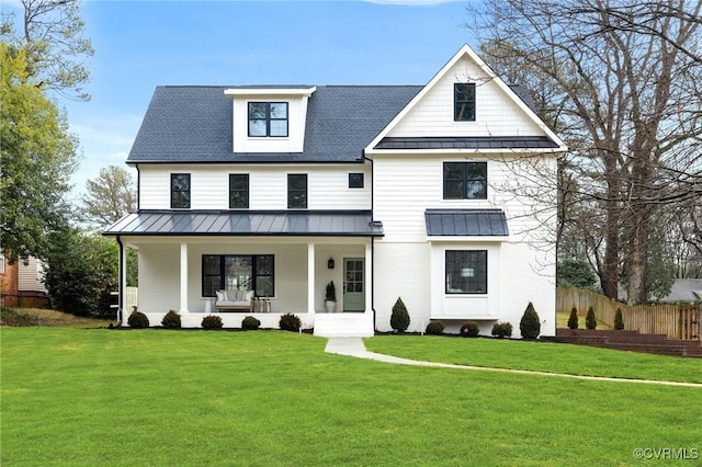 modern inspired farmhouse with covered porch and a front lawn