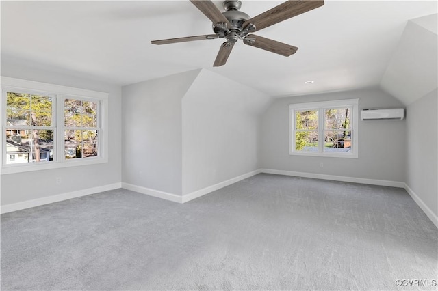 bonus room featuring vaulted ceiling, carpet, a wall mounted air conditioner, and ceiling fan