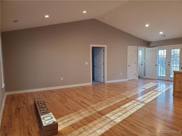 interior space featuring high vaulted ceiling, light hardwood / wood-style floors, and french doors