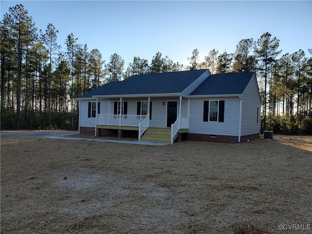 view of front of home with a porch and central AC