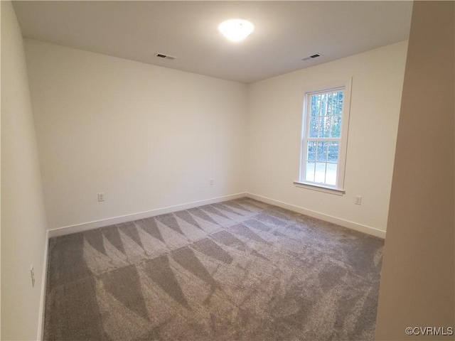 unfurnished room with dark carpet