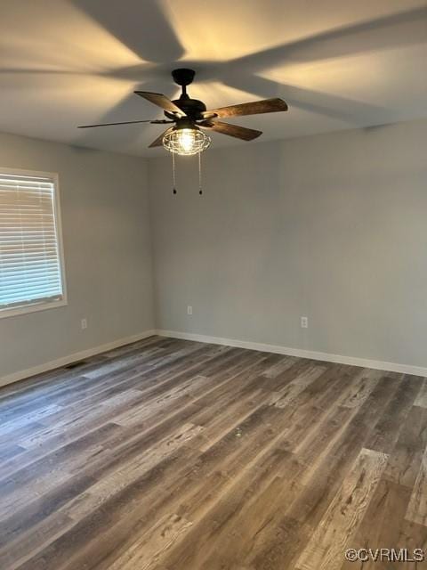 unfurnished room with dark hardwood / wood-style flooring