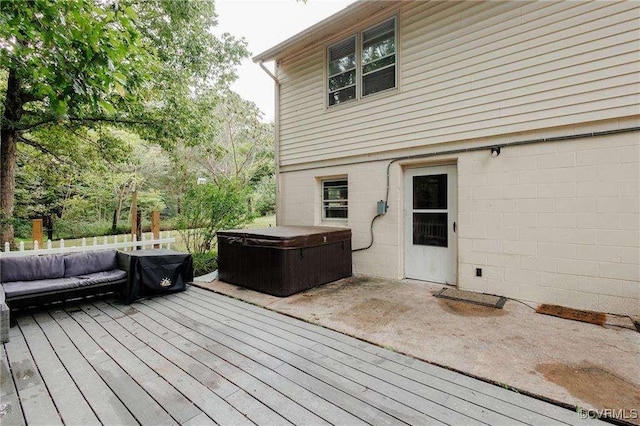 wooden deck with a hot tub