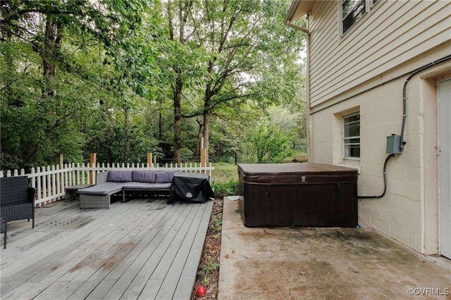 deck featuring outdoor lounge area and a hot tub