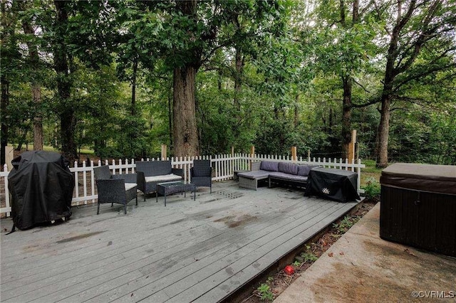 wooden deck featuring an outdoor living space, a hot tub, and grilling area