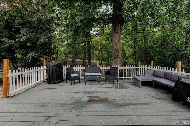 wooden deck with area for grilling and outdoor lounge area