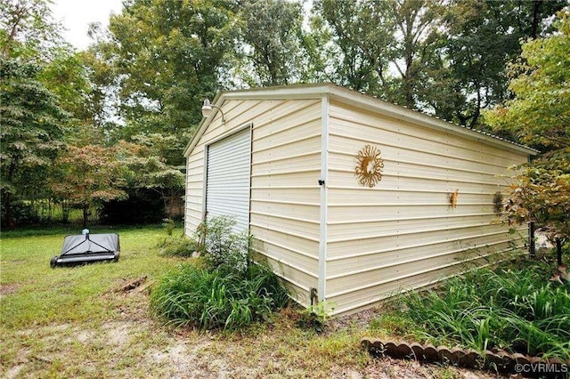 view of outbuilding featuring a lawn