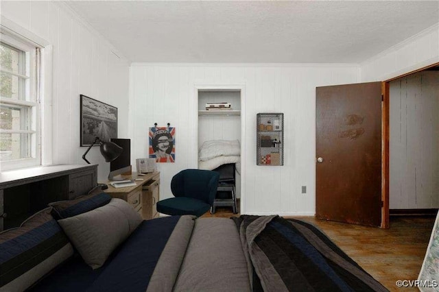 bedroom featuring wood-type flooring and crown molding