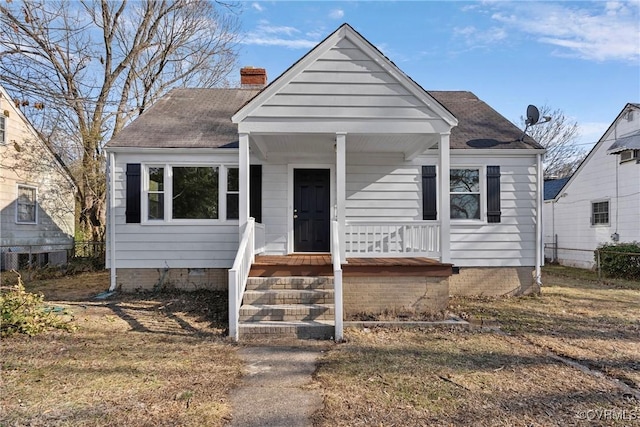 bungalow-style house with a front yard