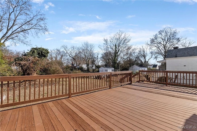 wooden deck featuring a storage unit