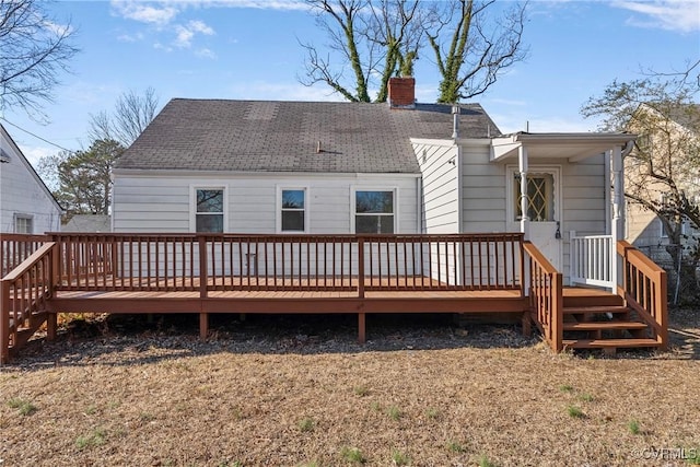 rear view of house featuring a wooden deck