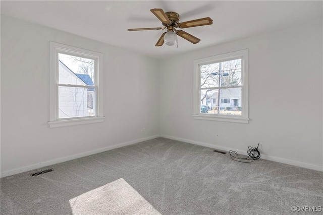 spare room featuring carpet and ceiling fan